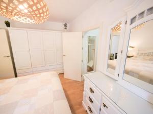 a bedroom with a bed and a large mirror at Chalet La Caballa Playa la Barrosa in Chiclana de la Frontera +82 photos