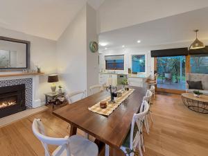 a dining room with a table and a fireplace at Gables on Malcolm in Mansfield