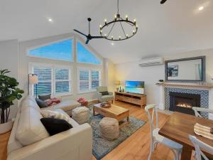 a living room with a couch and a fireplace at Gables on Malcolm in Mansfield