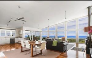 a living room with a couch and a table at Marcail Views Lakes Entrance in Lakes Entrance