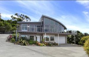 a large house with a lot of windows at Marcail Views Lakes Entrance in Lakes Entrance