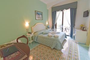 Postel nebo postele na pokoji v ubytování Hotel Santa Lucia