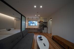 a living room with a couch and a table at 紀の川みんと静 in Kinokawa