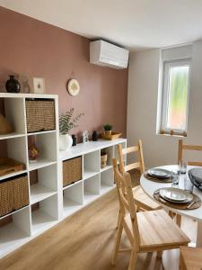a kitchen with a table and a dining room at Horizons du Haut in Niederbronn-les-Bains +12 photos