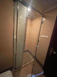 a shower stall in a bathroom with a toilet at فندق ريماس العنود in Mecca