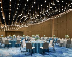 a banquet hall with tables and chairs and chandeliers at Thompson Shanghai Expo, by Hyatt in Shanghai +146 photos