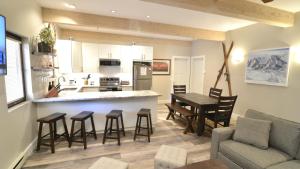 a kitchen and living room with a table and chairs at Sun Valley Adventures Heated Pool & Spa in Ketchum