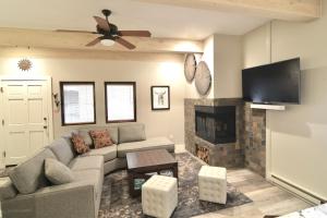 a living room with a couch and a fireplace at Sun Valley Adventures Heated Pool & Spa in Ketchum