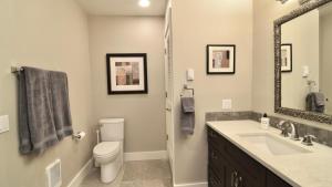 a bathroom with a toilet and a sink and a mirror at Sun Valley Adventures Heated Pool & Spa in Ketchum +17 photos