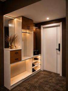 a walk in closet with white cabinets and a door at Margad Hotel in Ulaanbaatar +34 photos