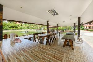 a pavilion with tables and chairs and a river at Reaunnapa Resort in Ban Nong Kham +59 photos