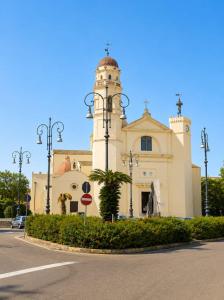 a building with a tower on the side of a street at Marconi 306 in Quartu Sant'Elena