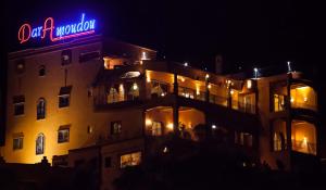 a building with a neon sign on it at night at Dar Amoudou in Ouarzazate