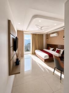 a hotel room with a large bed and a window at Ramasa Lake House in Bhīm Tāl