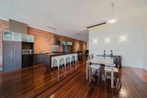 a kitchen with a dining table and a kitchen with a counter at Flinders 2 bed apartment near the Strand in Townsville