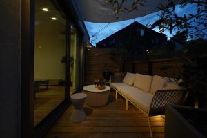 a porch with a couch and a table at 紀の川みんと間 in Kinokawa +21 photos