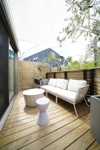 a patio with a couch and a coffee table at 紀の川みんと間 in Kinokawa