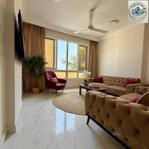 a living room with a couch and a table at المنصور 3 in Salalah +10 photos