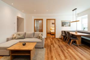 a living room with a couch and a table at Peak9 Apartment in Greifenburg