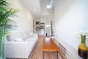 a living room with a white couch and a table at 紀の川みんと景 in Kinokawa