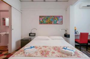 a bedroom with a bed and a red chair at Lungomare Casa Diaz in Cagliari +16 photos