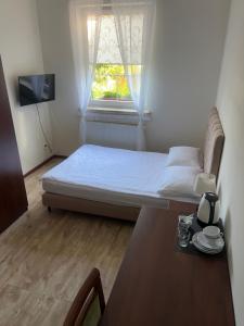a bedroom with a bed and a table and a window at Villa Marina in Dąbki +39 photos
