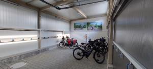 a row of bikes parked in a room at Hotel Sonnengarten in Sommerhausen