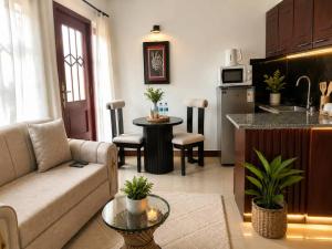 a living room with a couch and a kitchen at Kivulini Homes in Arusha