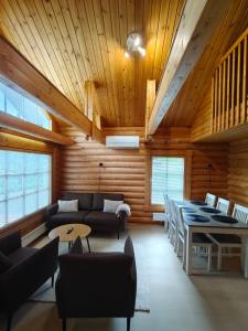 a living room with a couch and a table at Honkaranta Cottage in Jämsä