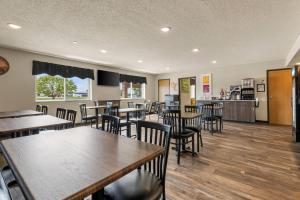 a dining room with wooden tables and chairs at Park Inn by Radisson Ortonville in Ortonville