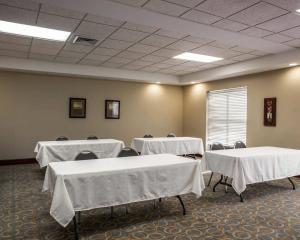 a conference room with tables and chairs with white table cloth at Comfort Inn & Suites Lumberton Central I-95 in Lumberton