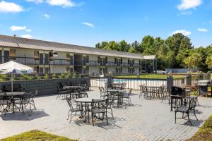 a patio with tables and chairs in front of a building at Quality Inn Sumter near Shaw AFB in Sumter