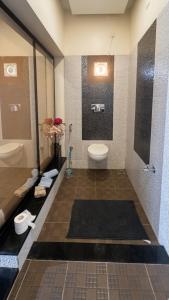 a bathroom with a toilet and a sink at The Grand Villa Kochi in Cochin +37 photos