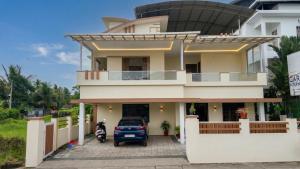 a house with a motorcycle parked in front of it at The Grand Villa Kochi in Cochin