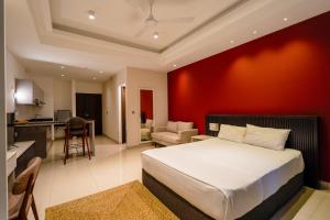 a bedroom with a white bed and a red wall at Ceylon Vacation - Negombo in Negombo +14 photos