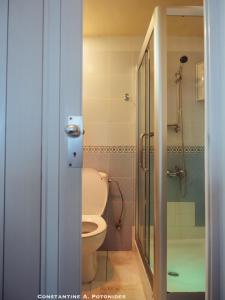 a bathroom with a toilet and a glass shower door at Sea Front & City Center, Amazing Sea View in Limassol