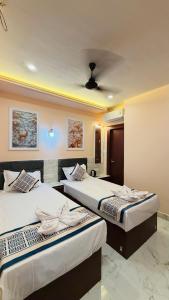 two beds in a hotel room with at Hotel Singh Palace in Varanasi +23 photos