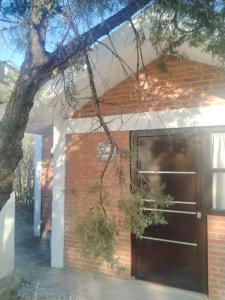 a brick house with a wooden garage door at Finca Itaca in San Esteban Tizatlán +12 photos