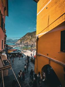 a group of people walking on a street next to a building at VERNAZZA CENTRALE in Vernazza