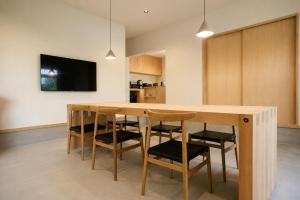a kitchen with a wooden table and chairs at 四方宿 in Hokuto