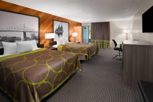 a hotel room with two beds and a desk at Super 8 by Wyndham Gananoque - Country Squire Resort in Gananoque +135 photos