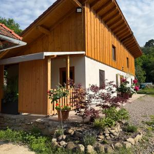 a large wooden building with flowers in front of it at ReziPáva Blue in Zăbala
