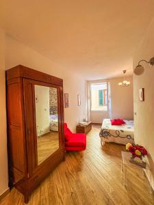 a room with a mirror and a bedroom with a bed at VERNAZZA CENTRALE in Vernazza