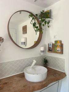 a bathroom with a white sink and a mirror at Bonair Tipi Village I Glamping in Călăţele +37 photos