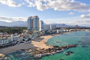 an aerial view of a beach with buildings and the ocean at Wyndham Goseong Gangwon Hotel in Goseong