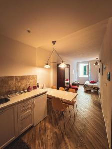 a kitchen and living room with a table and chairs at VERNAZZA CENTRALE in Vernazza