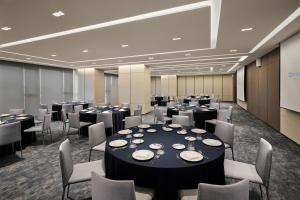 a conference room with tables and chairs and a screen at Wyndham Goseong Gangwon Hotel in Goseong +207 photos