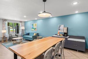 a living room with a table and a blue wall at WoodSpring Suites Atlanta Canton in Canton