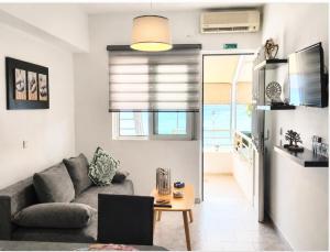 a living room with a couch and a table at Whisper wave in Haraki