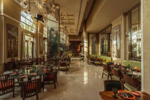 a restaurant with tables and chairs in a room at Rixos Premium Saadiyat Island - All Inclusive in Abu Dhabi